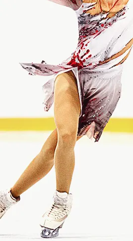 inga gurgenidze mid-skate during one of her 2023 free program skates. the edit is focused on her dress, which is white with fake tears on it and bloody handprints